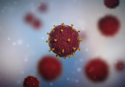 An illustration of a small number of virus particles on a blurred background.
